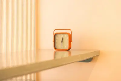 an orange clock sitting on a shelf in a room at Résidence Terre de Lys in Casablanca