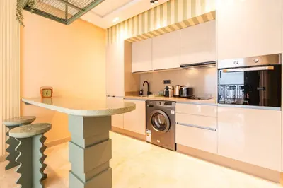 a kitchen with a counter and a washer and dryer at Résidence Terre de Lys in Casablanca
