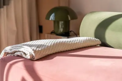 a pillow sitting on the edge of a bed at Résidence Terre de Lys in Casablanca