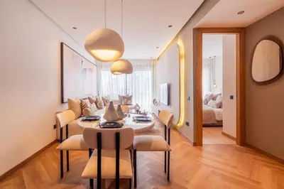 a living room with a table and chairs and a couch at Studio chic & moderne - Les Princesses - Parking in Casablanca