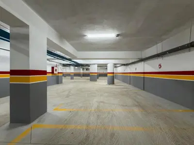 an empty parking garage with red yellow and white walls at Studio chic & moderne - Les Princesses - Parking in Casablanca