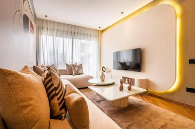 a living room with a couch and a table at Studio chic & moderne - Les Princesses - Parking in Casablanca