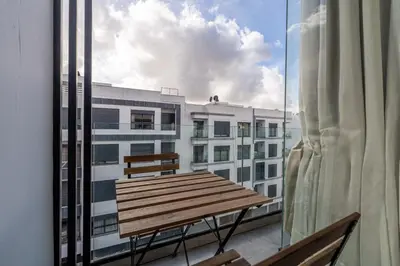 a wooden bench sitting on top of a balcony at Résidence Happy Living in Casablanca