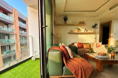 a living room with a couch and a window at Maya Suites - Anfa Place - Sea View in Casablanca