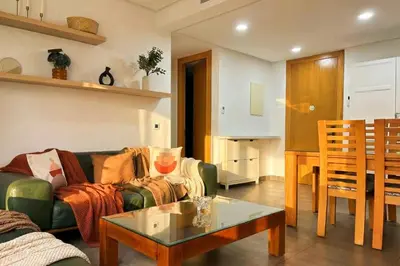 a living room with a couch and a table at Maya Suites - Anfa Place - Sea View in Casablanca