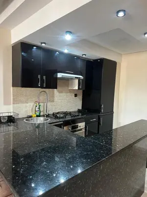 a kitchen with a black counter top and a sink at Appartement centre casablanca in Casablanca