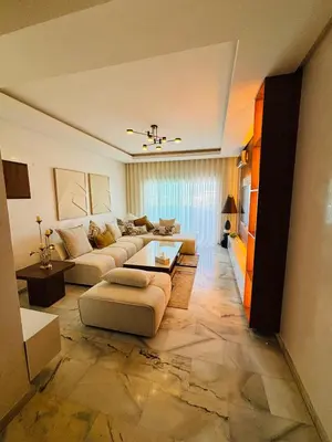 a large living room with couches and a table at Appartement la siesta beach resort in Mohammedia