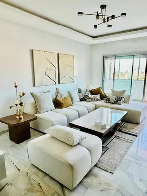 a large living room with couches and a table at Appartement la siesta beach resort in Mohammedia