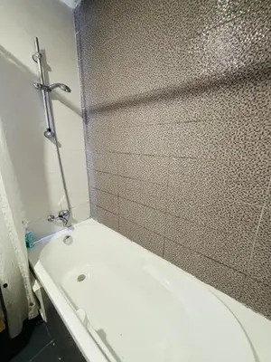 a bathroom with a shower and a toilet and a tub at Appartement la siesta beach resort in Mohammedia