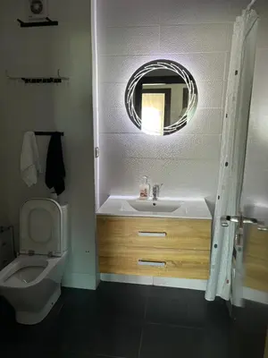a bathroom with a sink and a toilet and a mirror at Appartement la siesta beach resort in Mohammedia