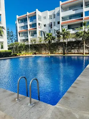 a large swimming pool in front of a building at Appartement la siesta beach resort in Mohammedia