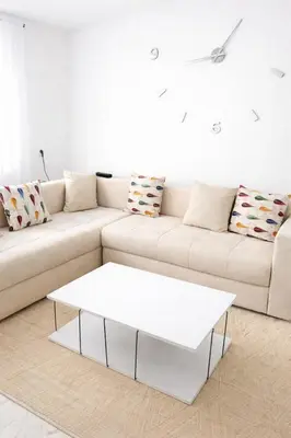 a white couch with a white coffee table in a living room at Appart luxe in Rabat