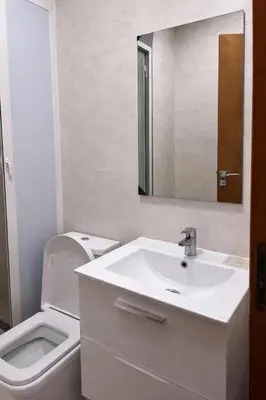 a bathroom with a sink and a toilet and a mirror at Diamonds in Rabat