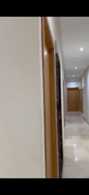 a hallway with a hallway leading to a room at Diamonds in Rabat