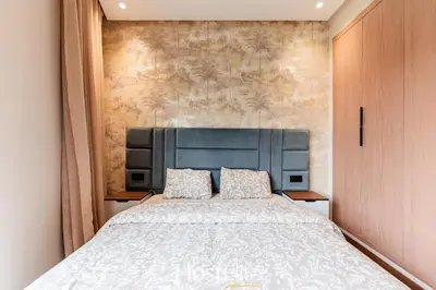 a bedroom with a large bed with a blue headboard at L'Harmonie in Casablanca