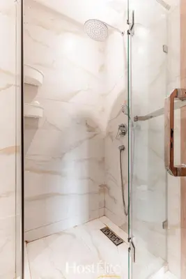a bathroom with a shower with white marble at L'Harmonie in Casablanca
