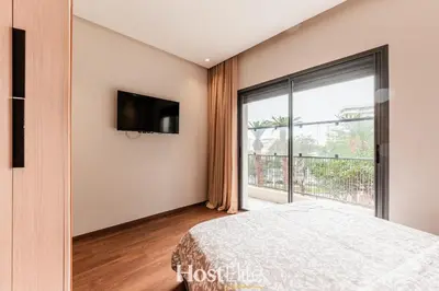a bedroom with a bed and a large window at L'Harmonie in Casablanca