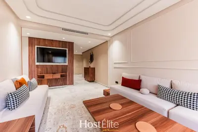 a living room with two white couches and a tv at L'Harmonie in Casablanca