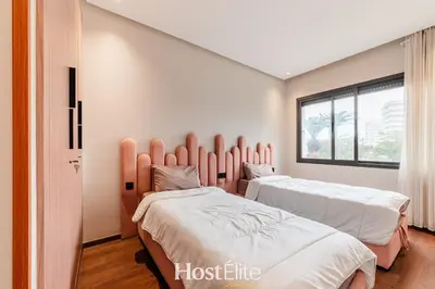 two beds in a room with a window at L'Harmonie in Casablanca