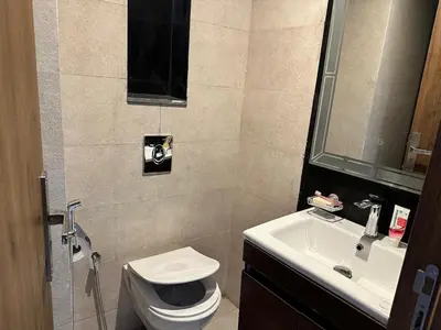 a bathroom with a toilet and a sink at luxury apartment in the city center in Rabat