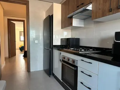 a kitchen with a stove and a refrigerator at luxury apartment in the city center in Rabat