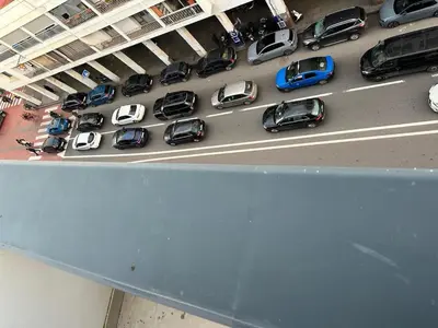 an overhead view of a parking lot filled with cars at luxury apartment in the city center in Rabat