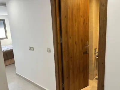 a wooden door in a room with a bedroom at luxury apartment in the city center in Rabat