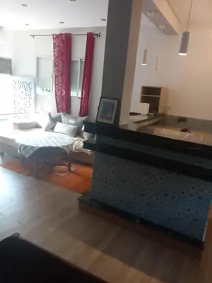 a living room with a couch and a table at Suite in nice résidence in Rabat