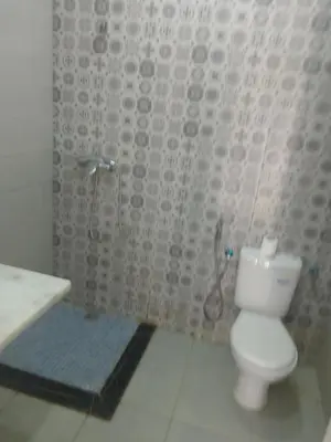 a bathroom with a toilet and a sink and a shower at Suite in nice résidence in Rabat