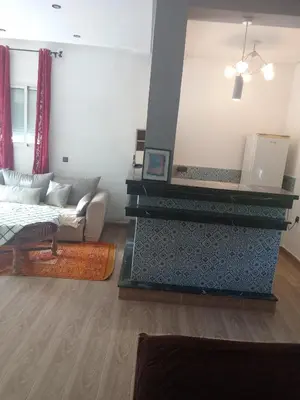 a living room with a couch and a fireplace at Suite in nice résidence in Rabat
