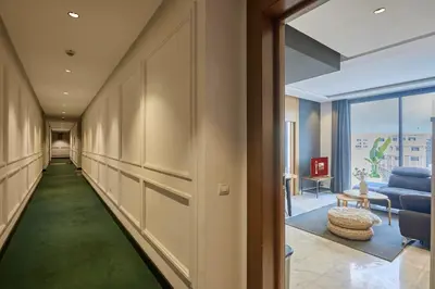a hallway with a green carpet in a room at Bright Studio at Bliving with Sunny Terrace 1 BR in Casablanca