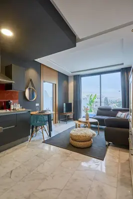 a living room with a couch and a table at Bright Studio at Bliving with Sunny Terrace 1 BR in Casablanca