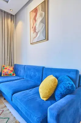 a blue couch with pillows on it in a living room at Sunlit loft with terrace-B living 1 Br in Casablanca
