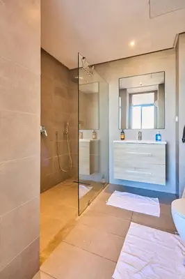 a bathroom with a shower and a toilet and a sink at Sunlit loft with terrace-B living 1 Br in Casablanca