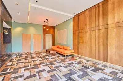 a lobby with an orange couch and a wall at Sunlit loft with terrace-B living 1 Br in Casablanca