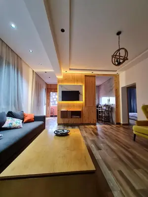 a living room with a couch and a tv at Adnan in Temara