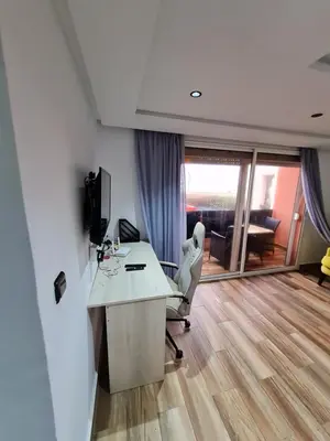 an office with a desk and a chair in a room at Adnan in Temara