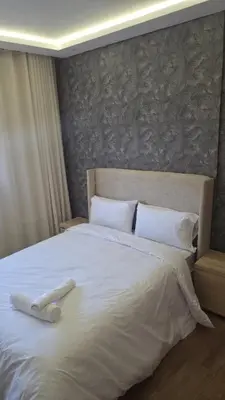 a large white bed with a white towel on it at Casa Downtown Modern Studio in Casablanca