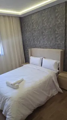 a large white bed with two white towels on it at Casa Downtown Modern Studio in Casablanca