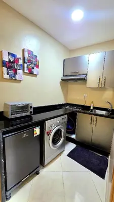 a kitchen with a washing machine and a sink at Casa Downtown Modern Studio in Casablanca
