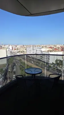 a table in a window with a view of a city at Casa Downtown Modern Studio in Casablanca