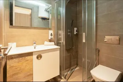 a bathroom with a shower and a sink and a toilet at Anfaflore2 in Casablanca