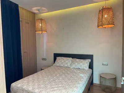 a bedroom with a bed with two lamps on it at Anfaflore2 in Casablanca