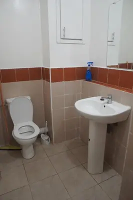 a bathroom with a toilet and a sink at Modern Apartment in Temara Near Beach & Rabat in Temara