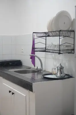 a kitchen counter with a sink and a plate at Modern Apartment in Temara Near Beach & Rabat in Temara