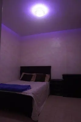 a bedroom with a bed with a purple ceiling at Modern Apartment in Temara Near Beach & Rabat in Temara