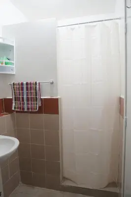 a bathroom with a shower curtain and a sink at Modern Apartment in Temara Near Beach & Rabat in Temara