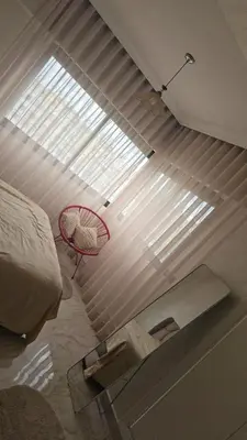 a bedroom with a window and a red basket at Corniche in Casablanca