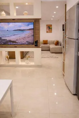 a living room with a large flat screen tv at Corniche in Casablanca