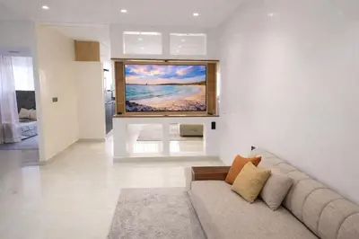 a living room with a couch and a painting on the wall at Corniche in Casablanca